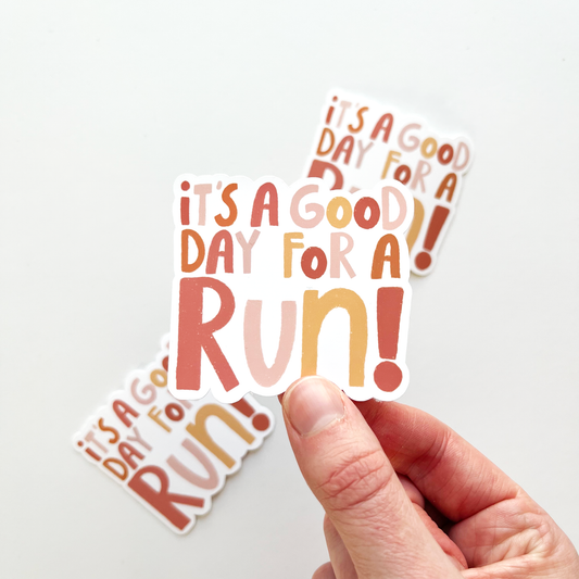 It's a good day for a run sticker in alternating colors of pink, yellow and orange