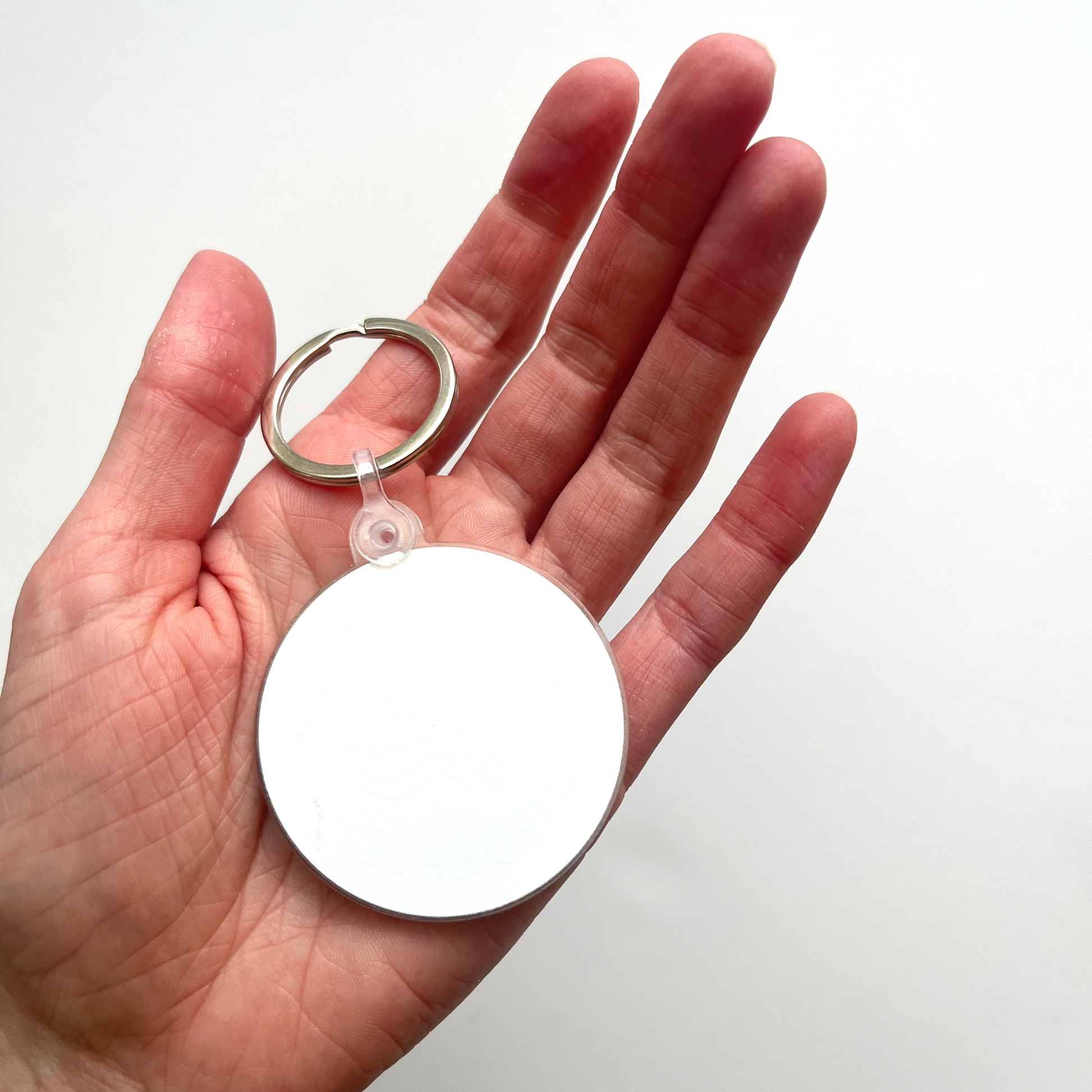 Backside of circle keychain which is blank white