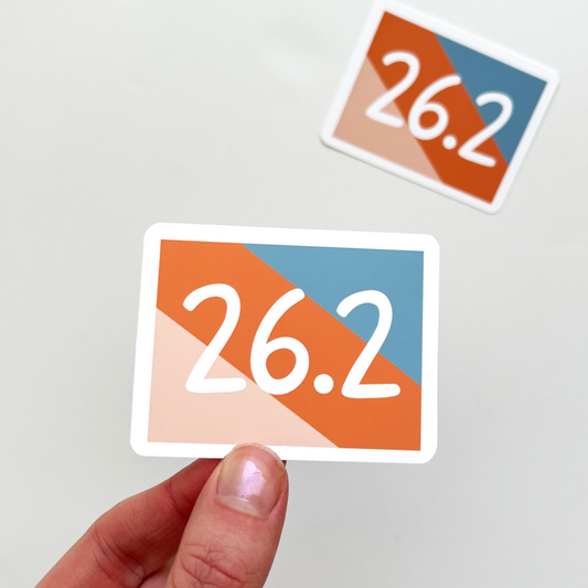 Rectangle sticker with slanted stripes of pink, orange and blue. 26.2 is written in the center in white text.