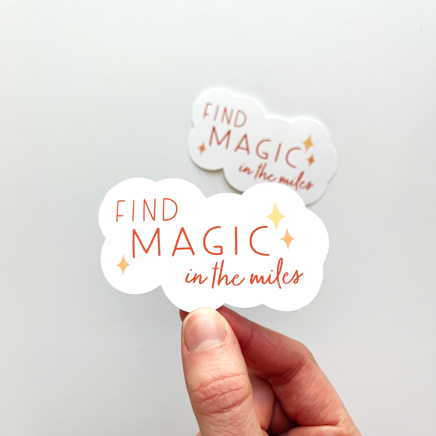 Find magic in the miles sticker in the shape of a white cloud with deep orangey red text