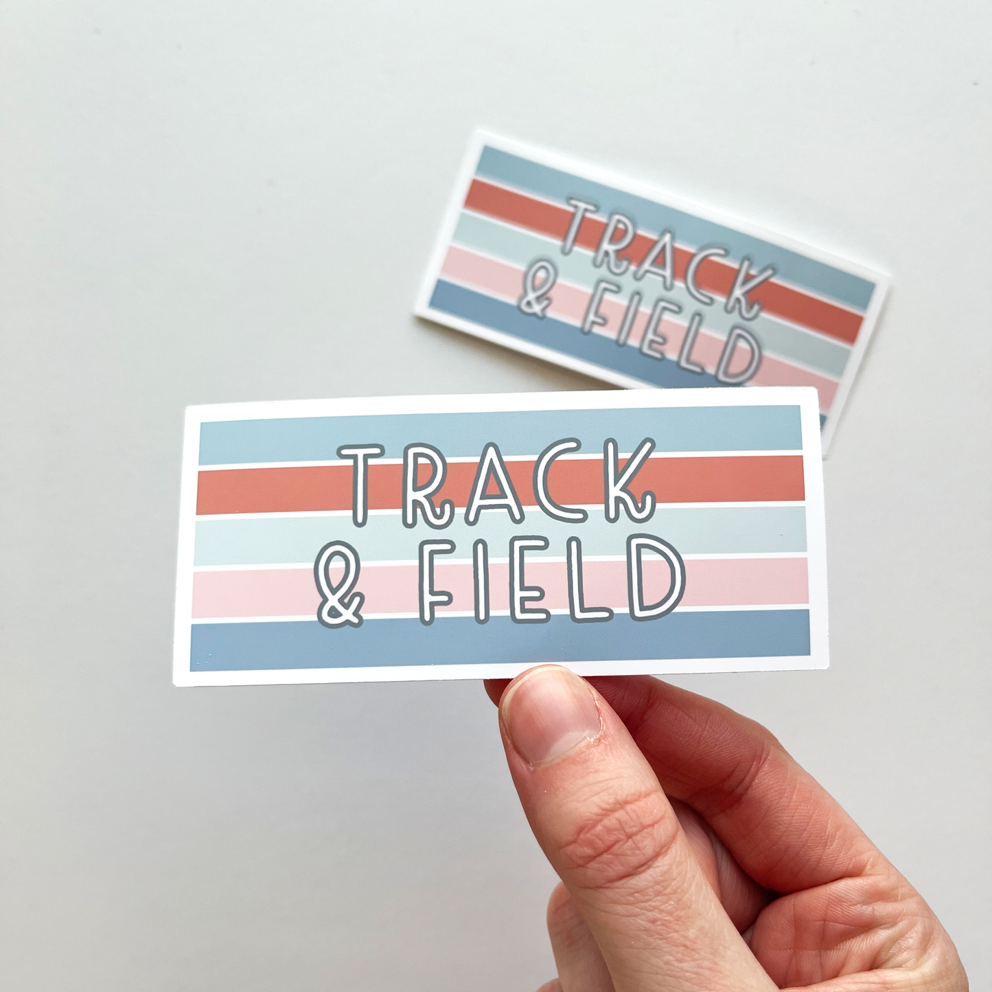 Track And Field Rectangle Sticker with horizontal stripes of blue, red, light blue, pink and dark blue