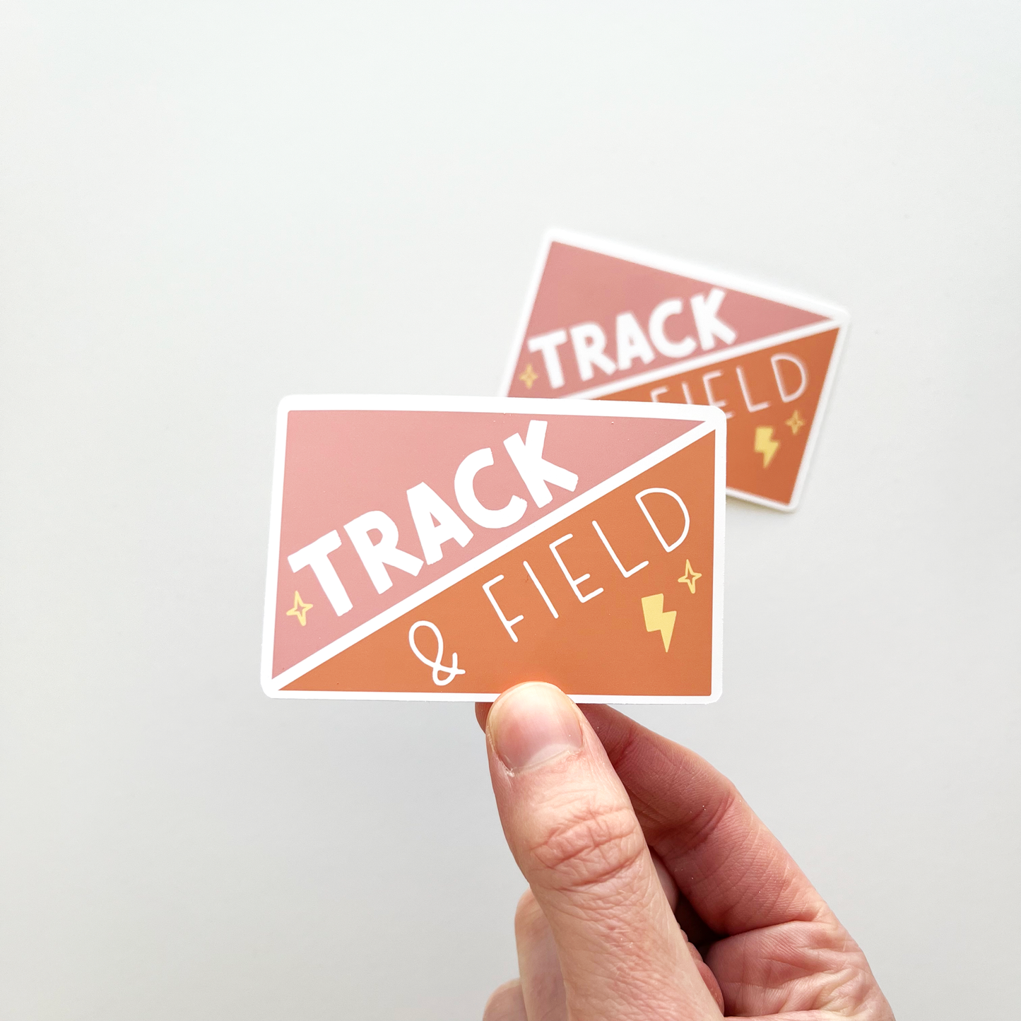 Track and field rectangular sticker in pink and orange