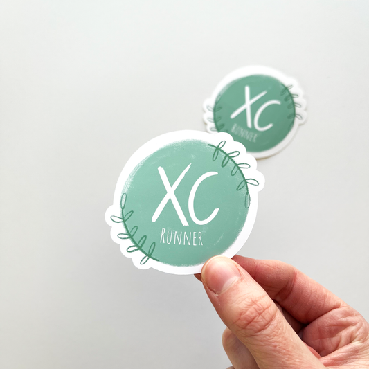 XC runner sticker with white text in a teal circle