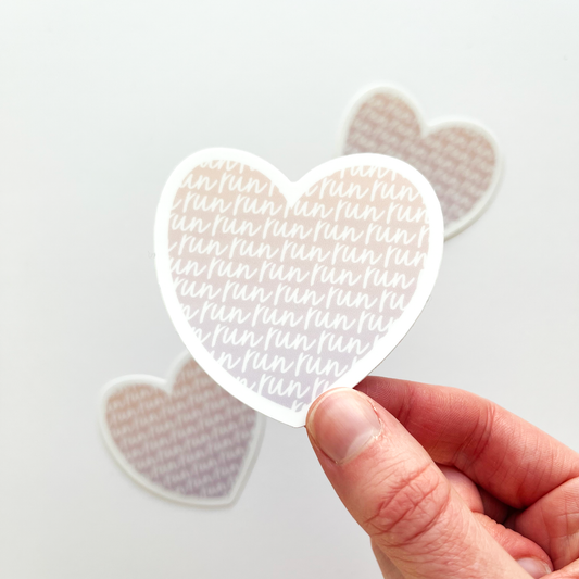 Heart shaped sticker filled with repeating word run on pinkish to purple ombre background
